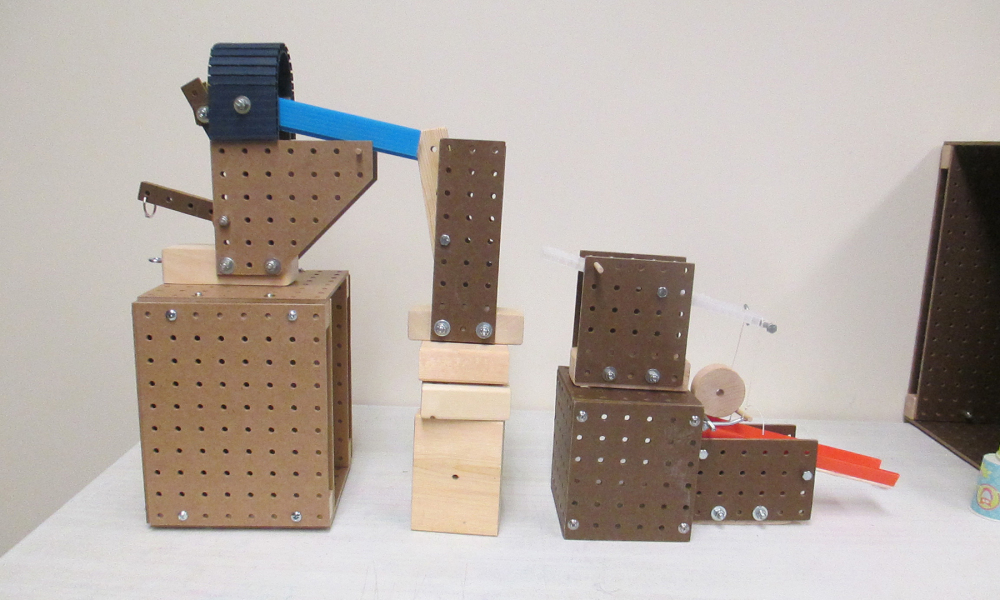 Use a variety of blocks, balls, ramps, string, and other materials.