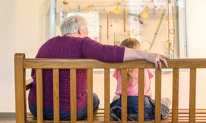 grandmother and child sitting on bench