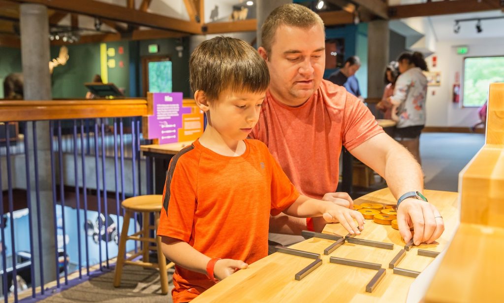 adult and child building on a table