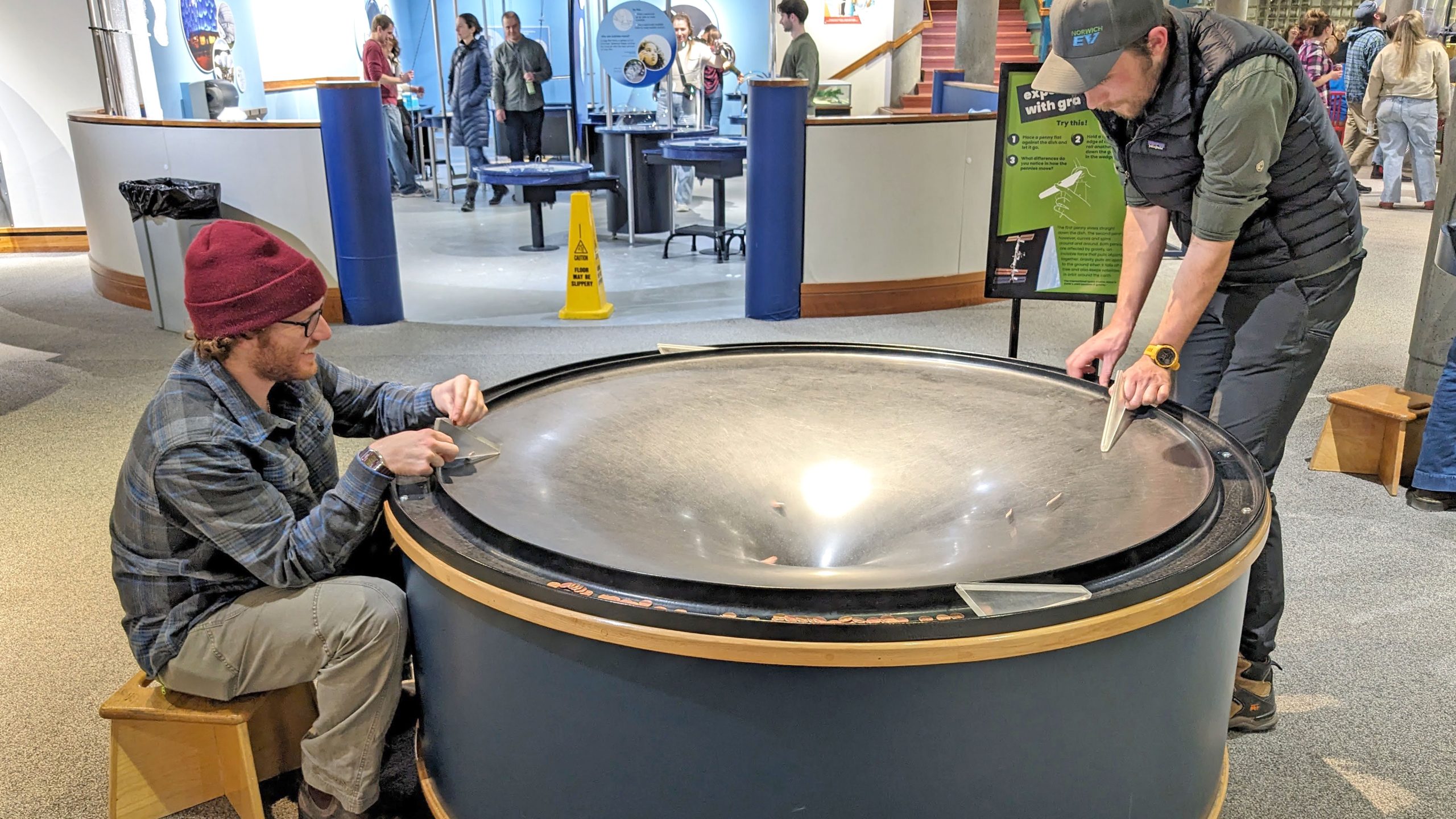 Two visitors experimenting with the Penny Well