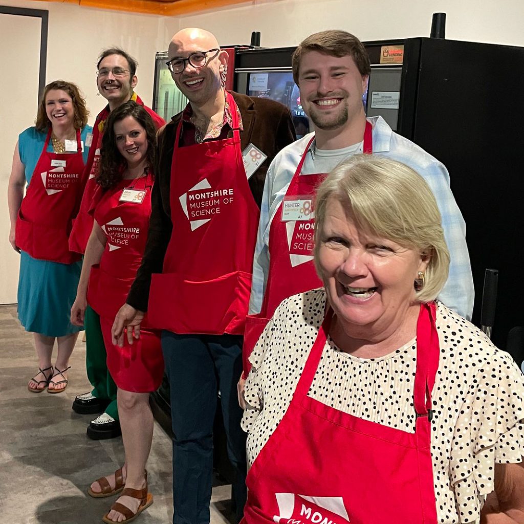 Montshire Staff standing together wearing red aprons