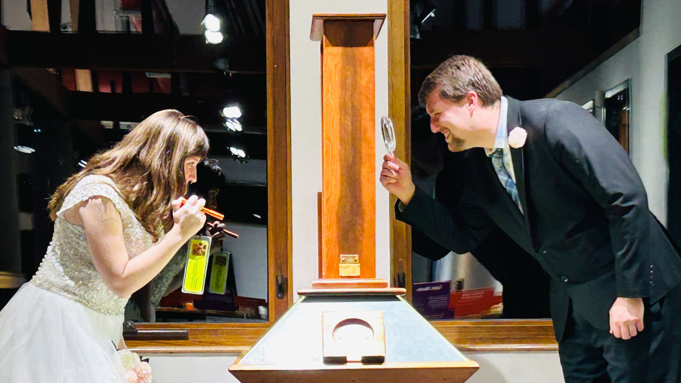 A wedding couple look closely at the Montshire's honeybee hive