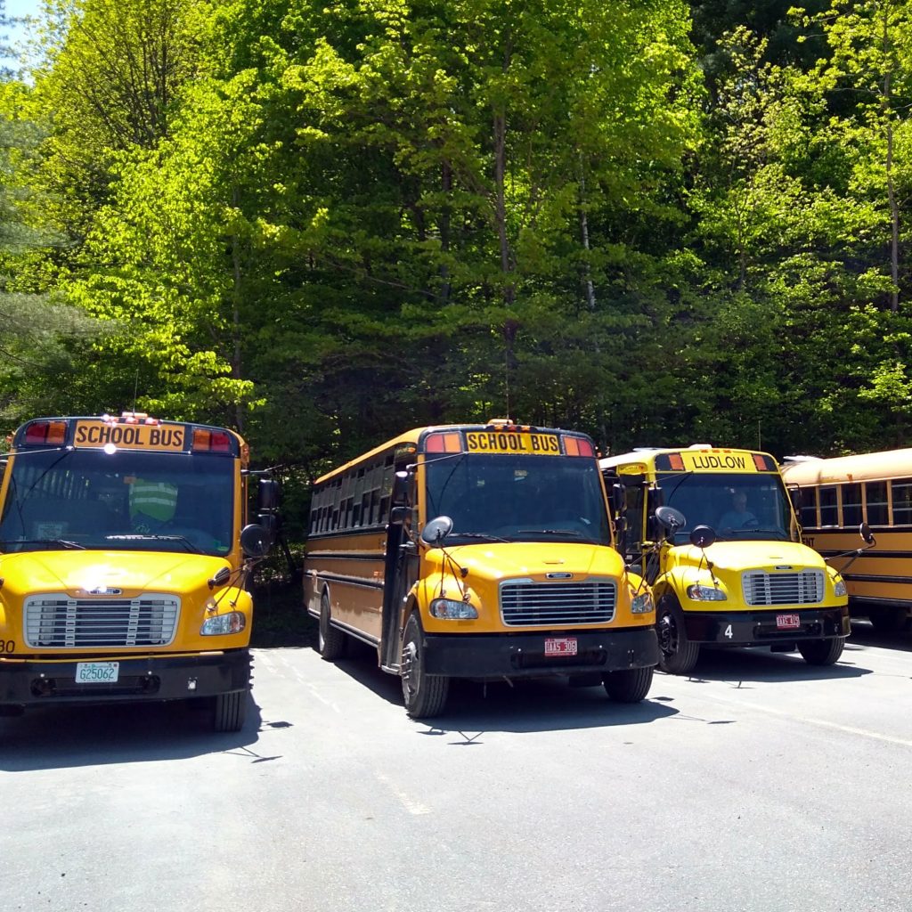 Four school buses in the Montshire parking lot
